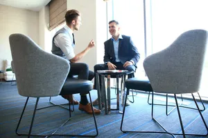Men conversing in casual chairs
